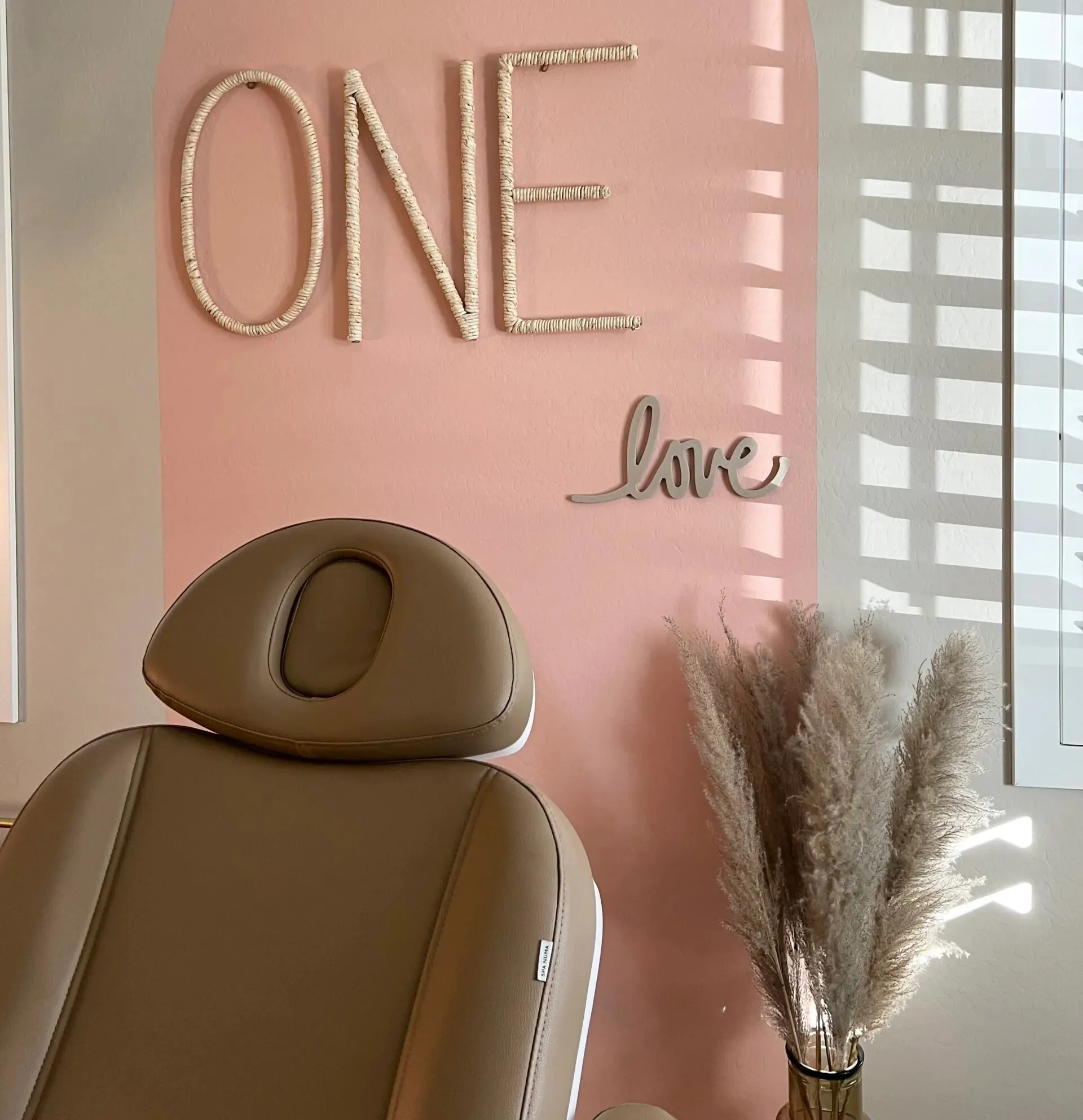 Clean, professional medical spa treatment room with neutral tones at One Love Medical Aesthetics in Mesa