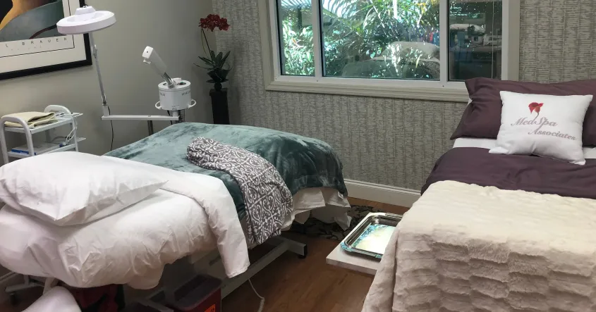 Clean, professional medical spa treatment room with neutral tones at Medspa Associates in Naples