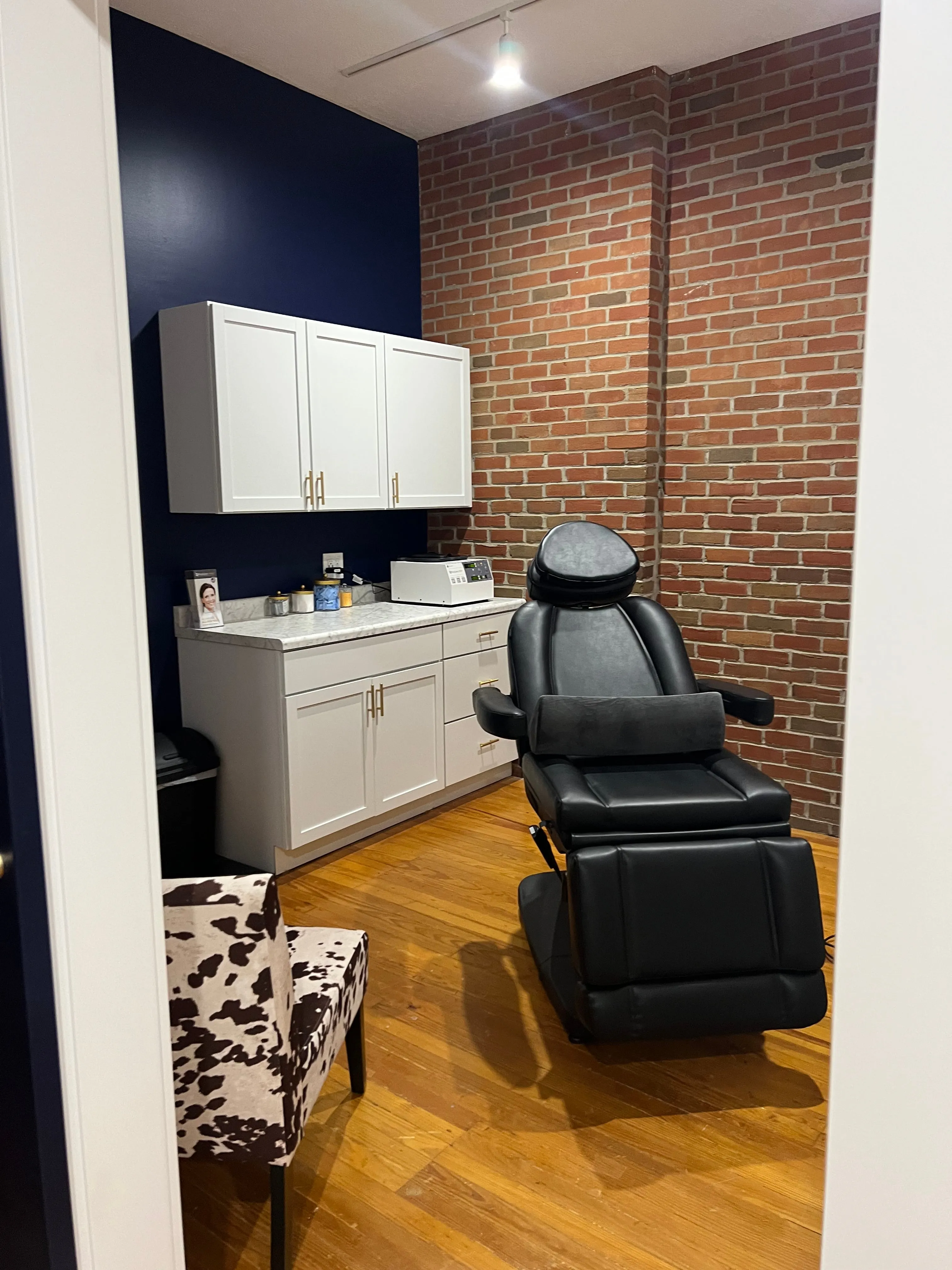 Clean, professional medical spa treatment room with neutral tones at Renew Wellness and Aesthetics, LLC in London
