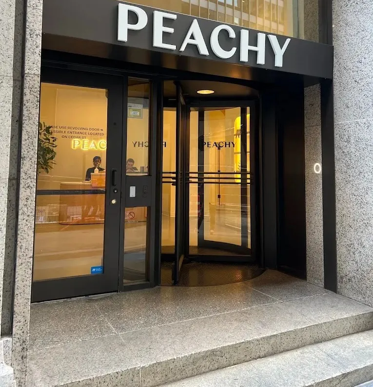 Clean, professional medical spa treatment room with neutral tones at PEACHY - Fidi in New York
