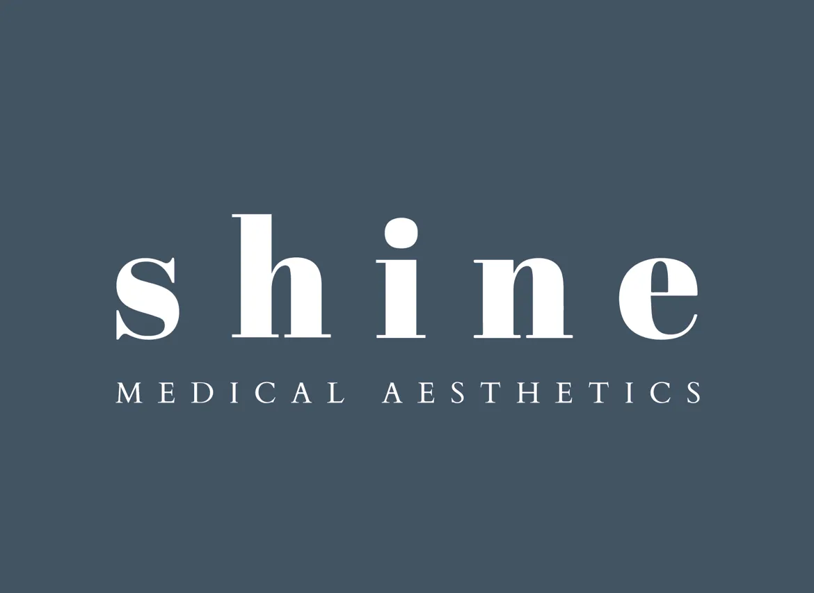 Clean, professional medical spa treatment room with neutral tones at Shine Medical Aesthetics Avalon in Alpharetta
