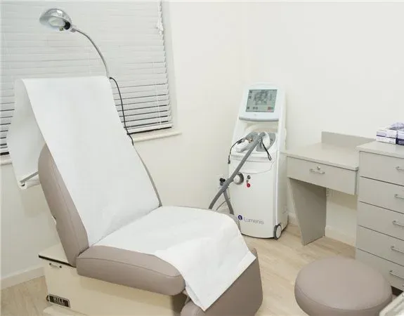 Clean, professional medical spa treatment room with neutral tones at Lumos Dermatology in New York