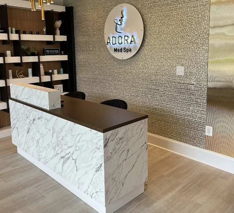 Clean, professional medical spa treatment room with neutral tones at Adora Aesthetics in Clarksville