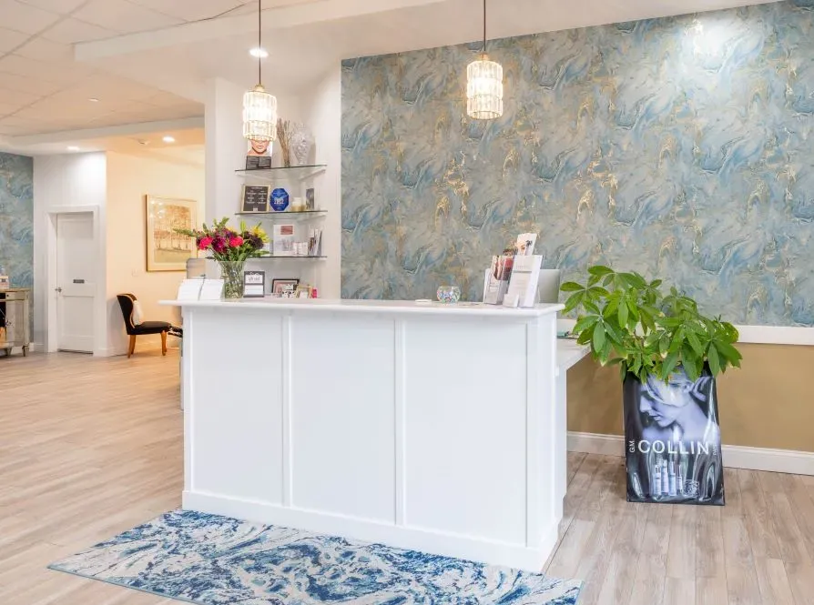 Clean, professional medical spa treatment room with neutral tones at Essential Adv Skincare & Medspa in Dedham