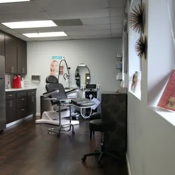Clean, professional medical spa treatment room with neutral tones at Allure Aesthetics in Novato