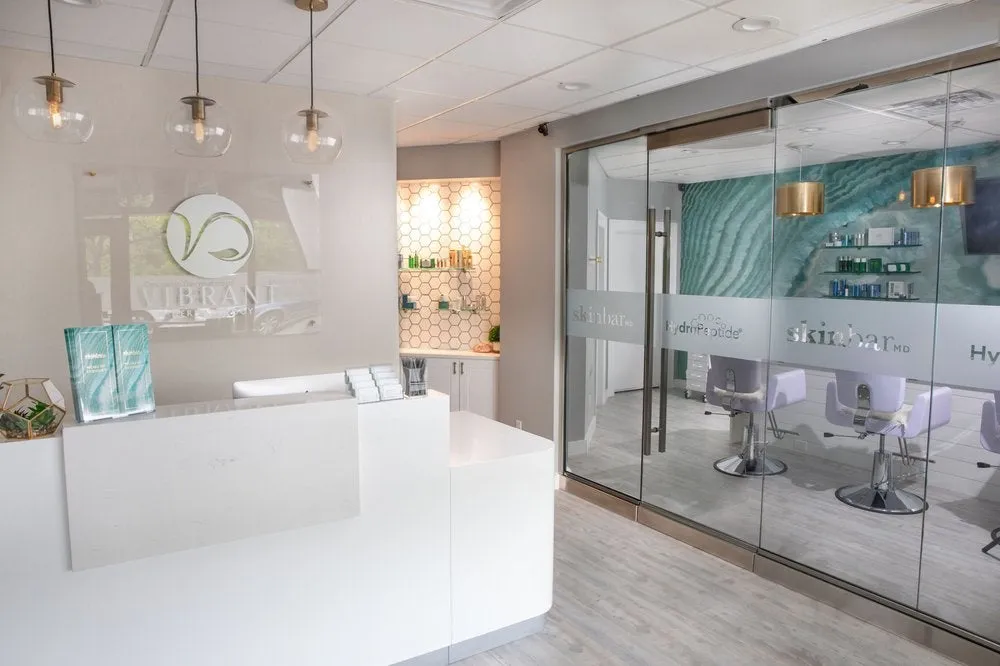 Clean, professional medical spa treatment room with neutral tones at Vibrant Dermatology in Dedham