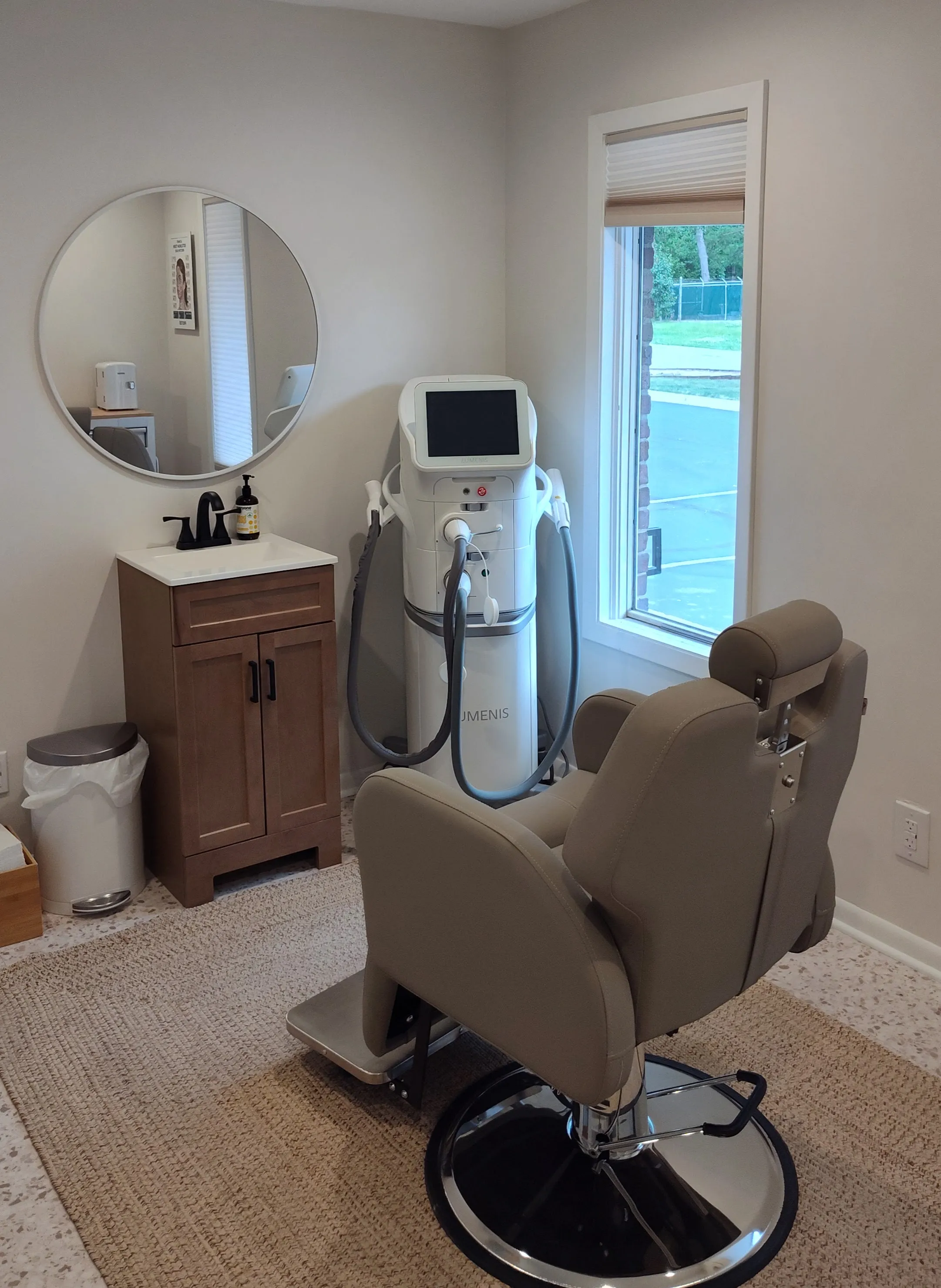 Clean, professional medical spa treatment room with neutral tones at Emerging Grace, LLC in Prairie Village